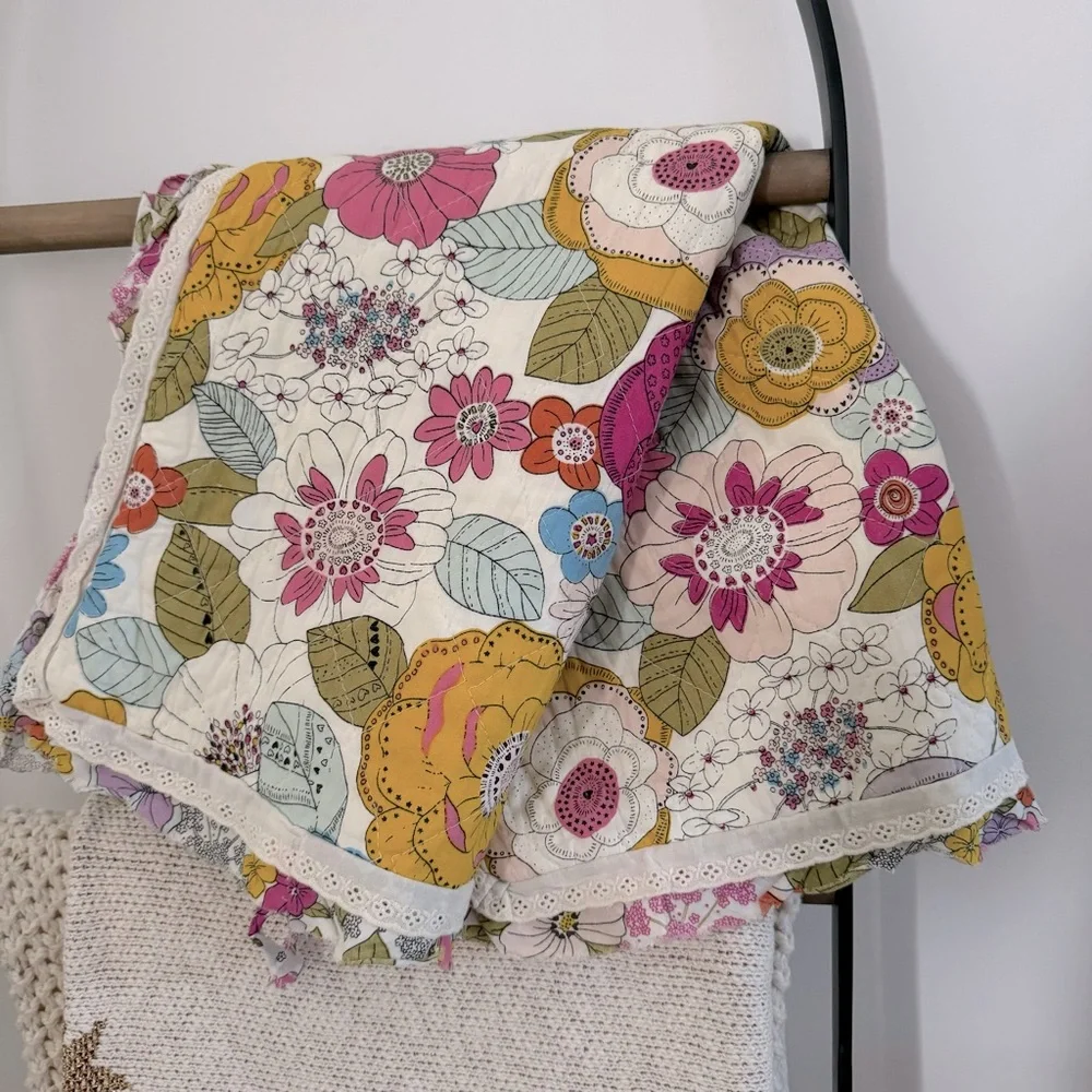 Cynthia Rowley quilted pillow sham with a multicolored boho floral pattern.